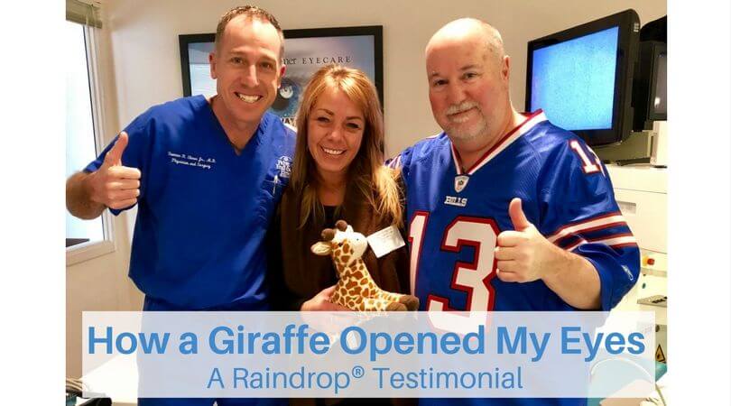 Dr. Elmer and Kevin O'Brien standing with their thumbs up, next to Vanessa Miller (holding a stuffed toy giraffe), after a successful Raindrop procedure