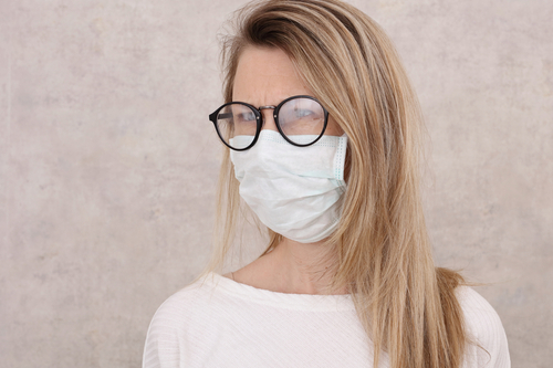woman with fogged up glasses from wearing mask 