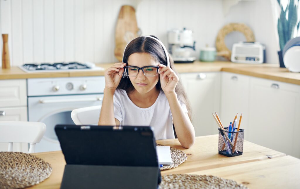 young girl squinting at the screen