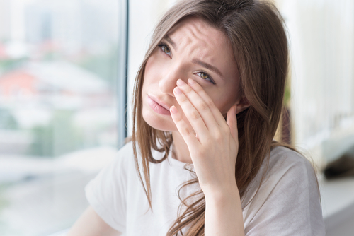 Woman wiping eyes