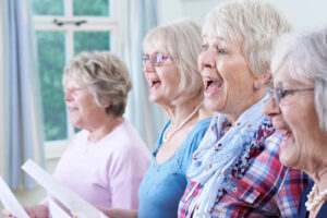 group of four women singing 